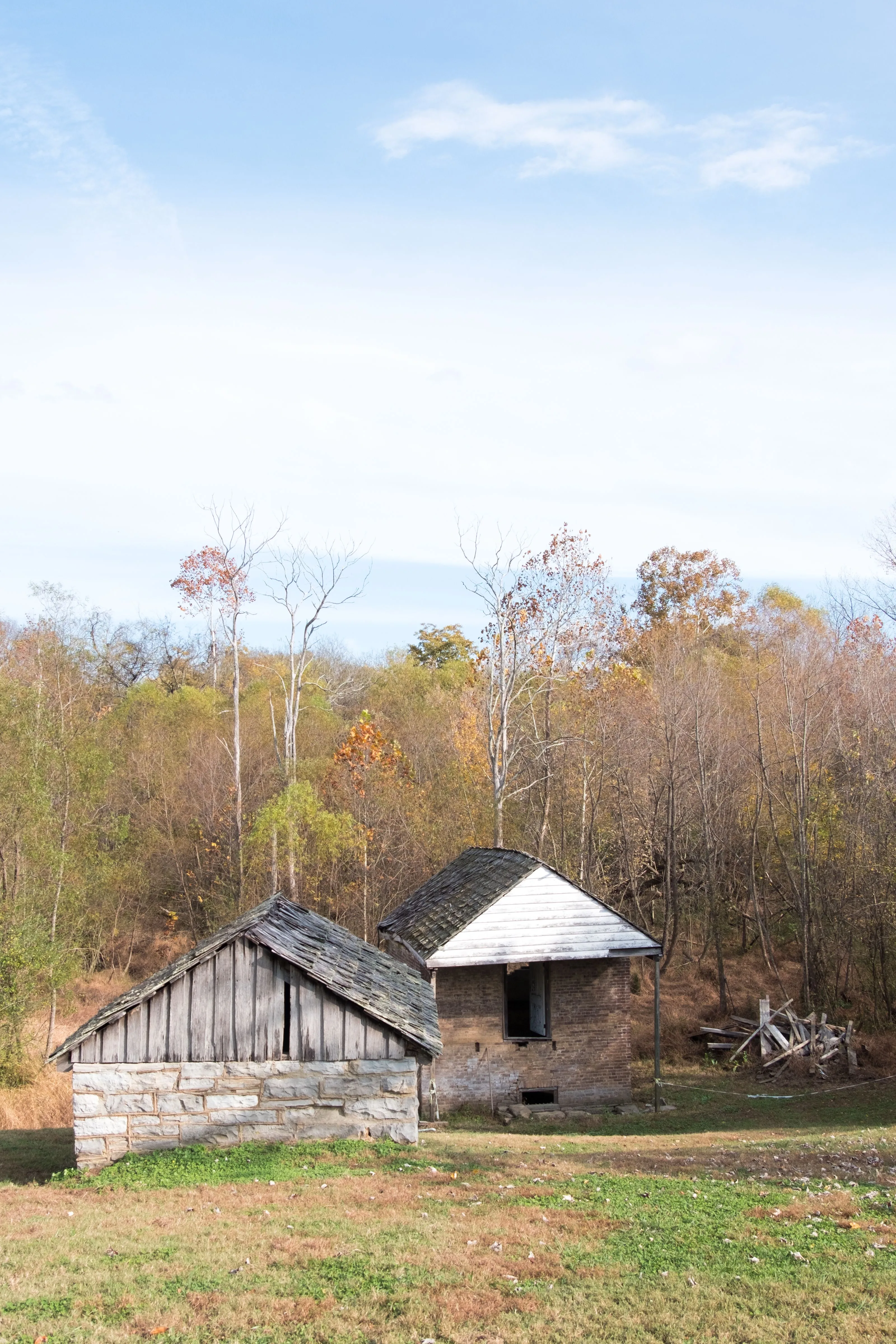 Vertical shot of old slave dwellings backdropped by autumn trees near Carnton Plantation, Tennessee